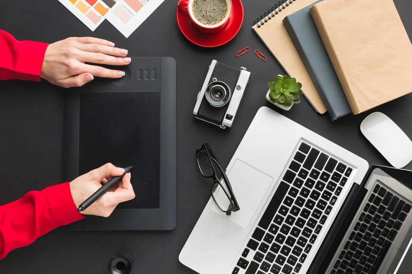 Draufsicht auf einen Zeichenblock auf einem Schreibtisch mit Laptop